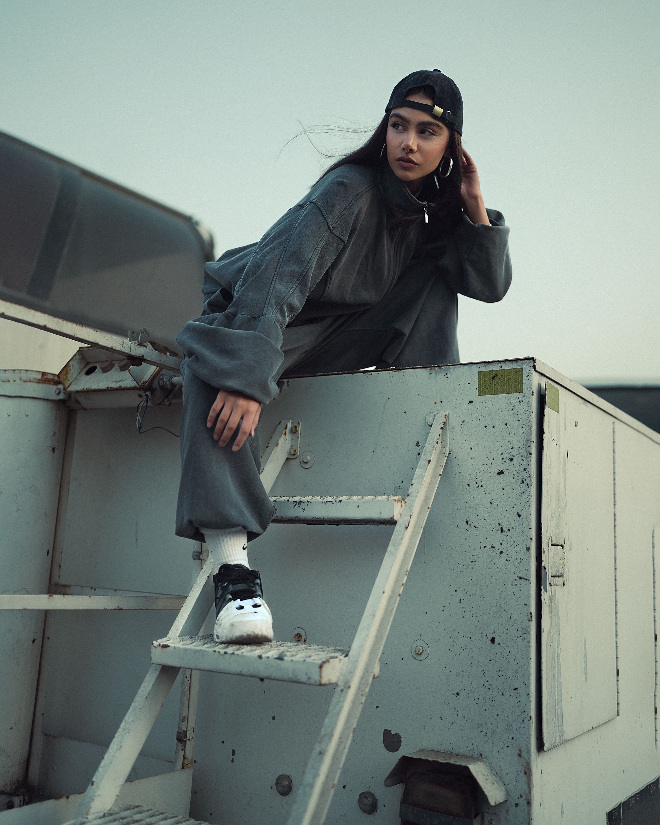 Kumoi model in a dark urban rooftop setting